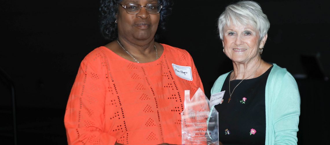 Longtime Habitat for Humanity volunteer Marie Kilgore (left) accepts the Volunteer Appreciation Award from founding Habitat for Humanity MCTN board member Amelia Wallace (right).